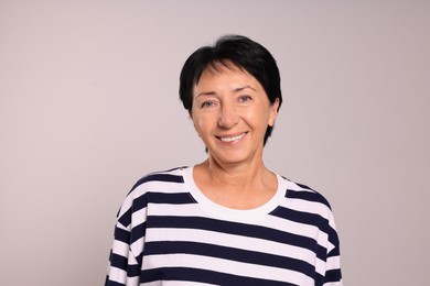 Photo of Portraitsmiling senior woman on light grey background