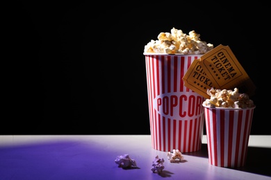 Delicious popcorn and tickets on table. Space for text