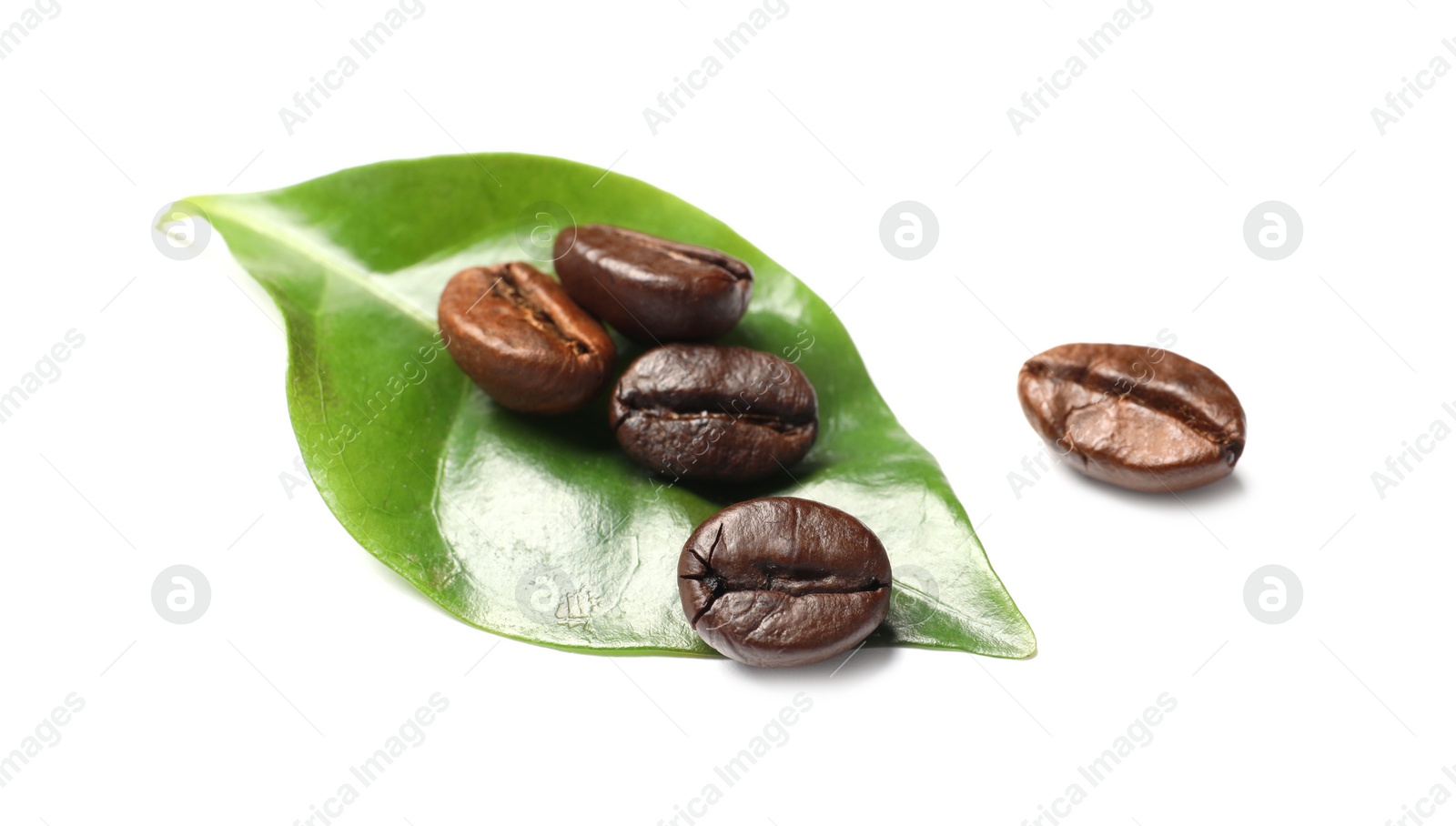 Photo of Roasted coffee beans and green leaf on white background