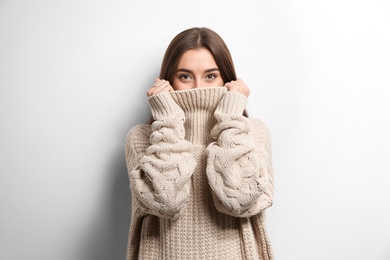 Photo of Beautiful young woman in warm sweater on white background