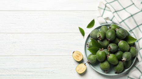 Fresh green feijoa fruits on white wooden table, flat lay with space for text. Banner design