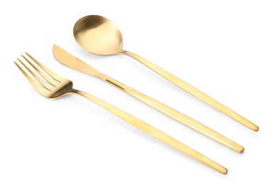 Photo of Shiny golden fork, knife and spoon isolated on white. Luxury cutlery set