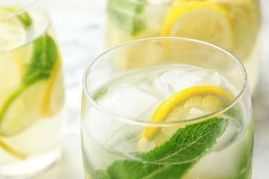 Photo of Glass of refreshing lemonade on table, closeup. Summer drink