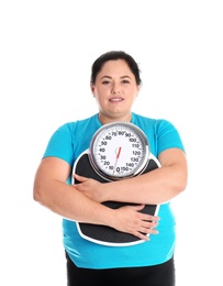 Overweight woman in sportswear with scales on white background