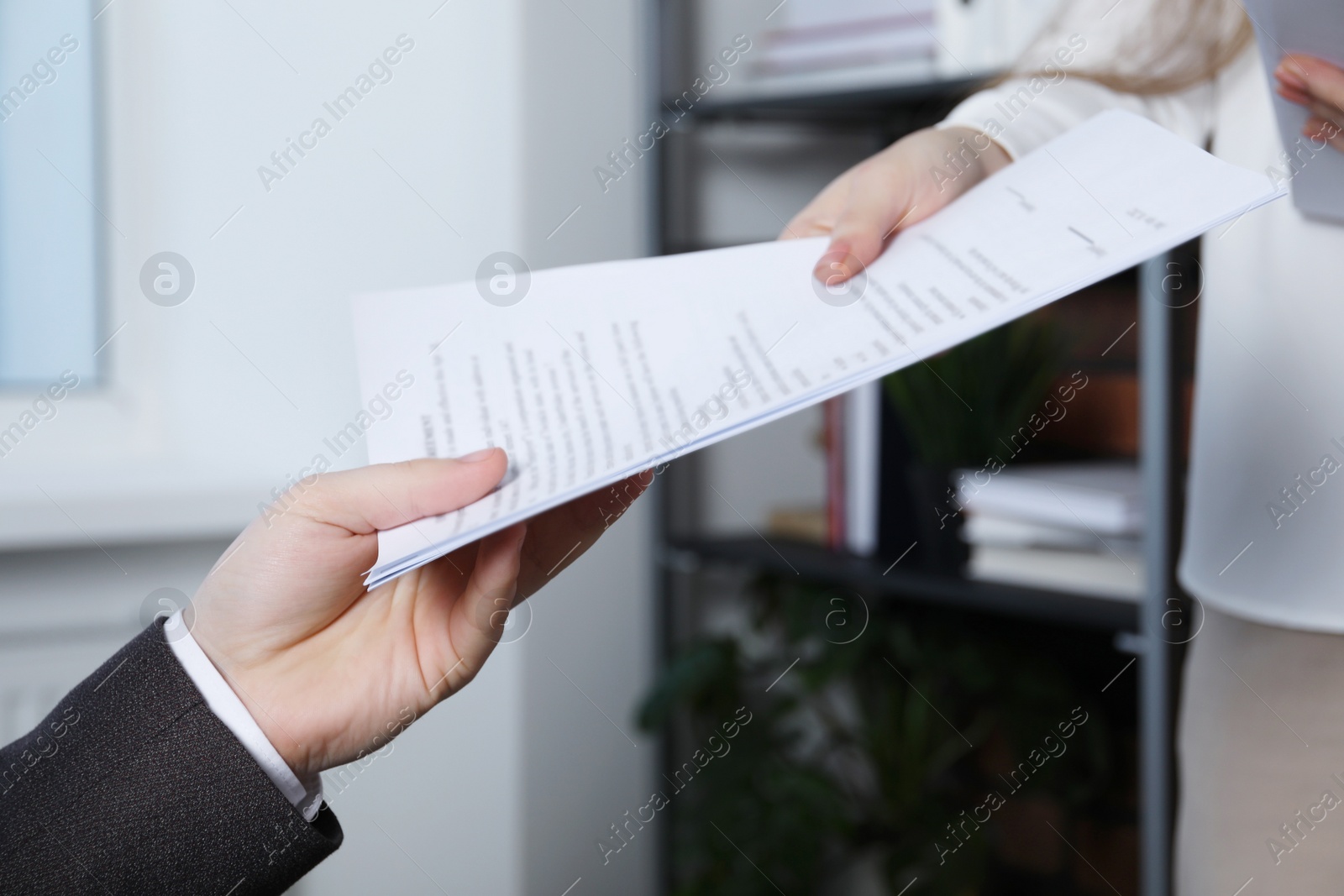 Photo of Woman giving many documents to man in office, closeup