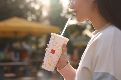 Photo of Lviv, Ukraine - September 26, 2023: Woman with McDonald's drink outdoors, closeup. Space for text