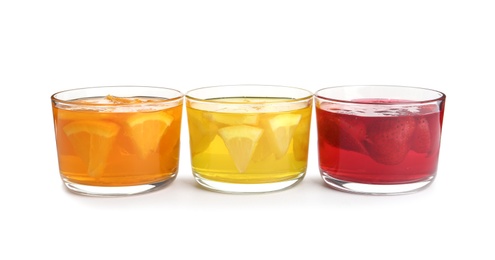 Photo of Tasty jelly desserts in glasses on white background