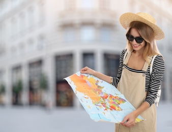 Happy traveler with map in foreign city. Summer vacation trip