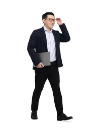 Businessman in suit with laptop walking on white background