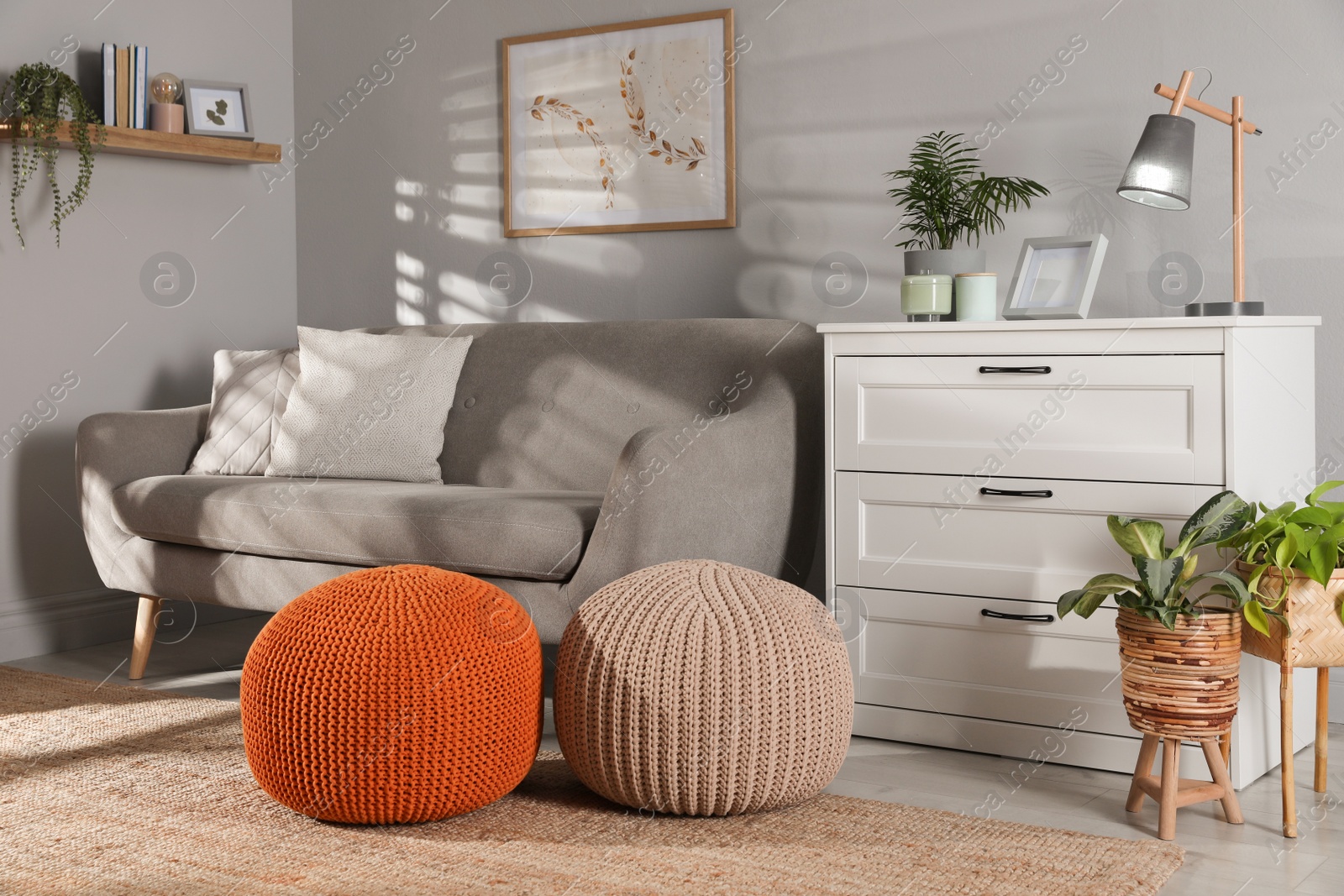 Photo of Stylish knitted poufs and sofa in living room. Home design