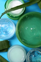 Aloe and different cosmetic products on light blue background, flat lay