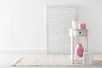 Photo of Living room interior with vases and table near white wall. Space for text