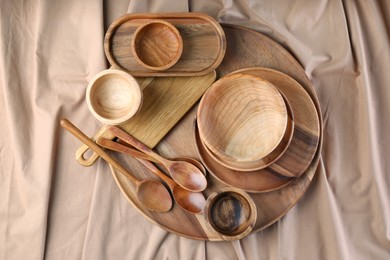 Photo of Set of wooden dishware and utensils on table, flat lay