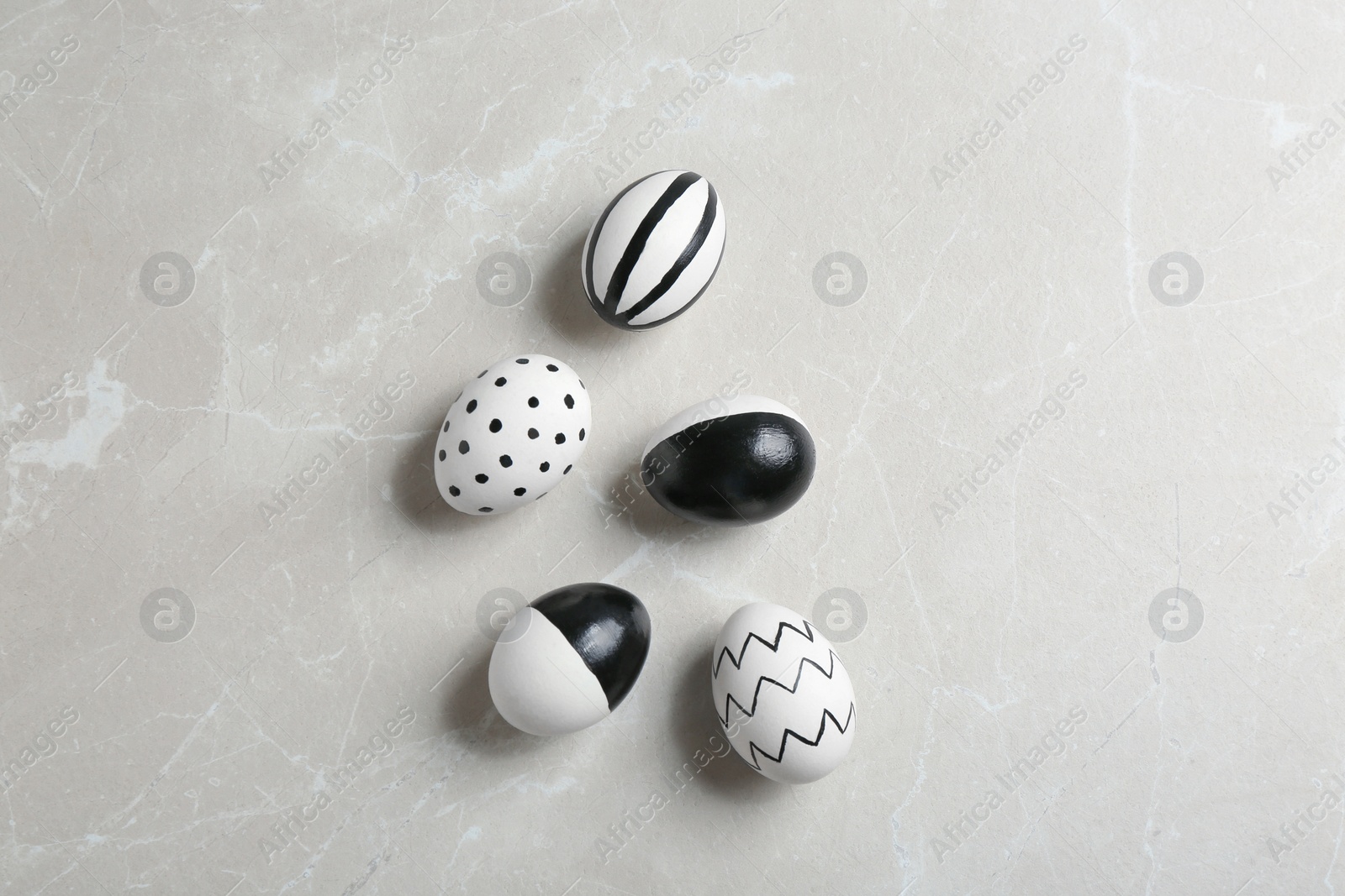 Photo of Painted Easter eggs on grey background, flat lay