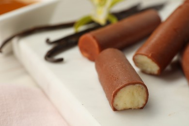 Photo of Glazed vanilla curd cheese bars served on table, closeup