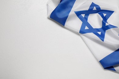 Photo of Flag of Israel on white textured background, above view and space for text. National symbol