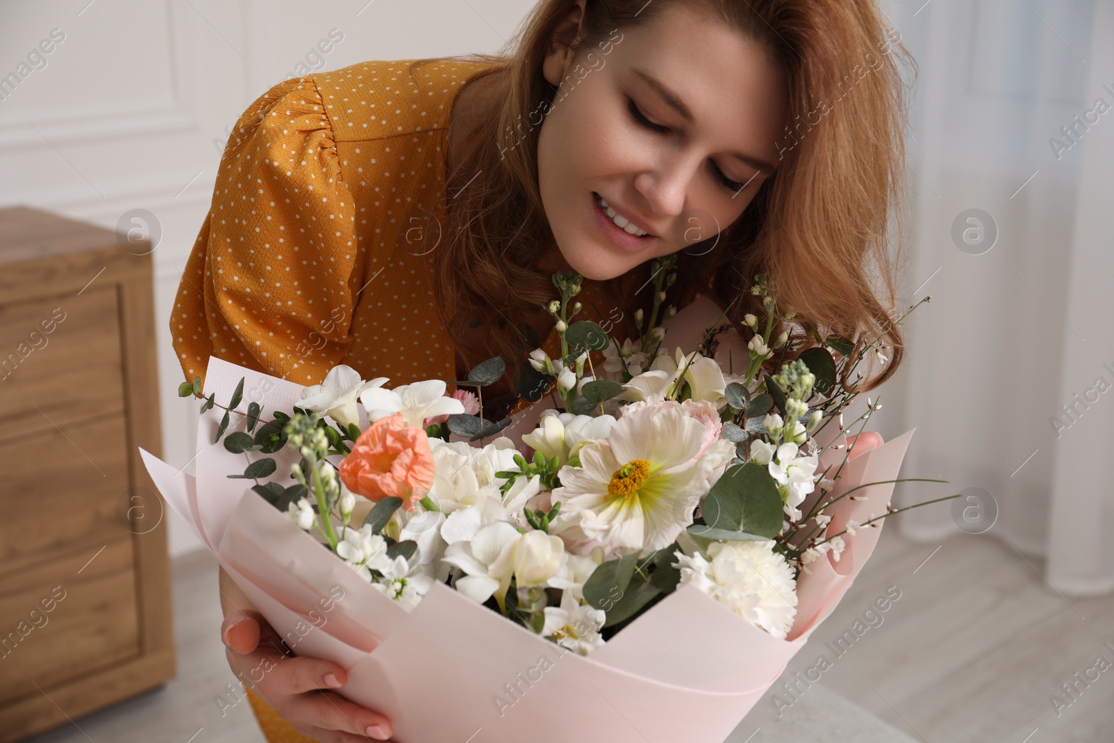 Photo of Beautiful woman with bouquet of flowers indoors