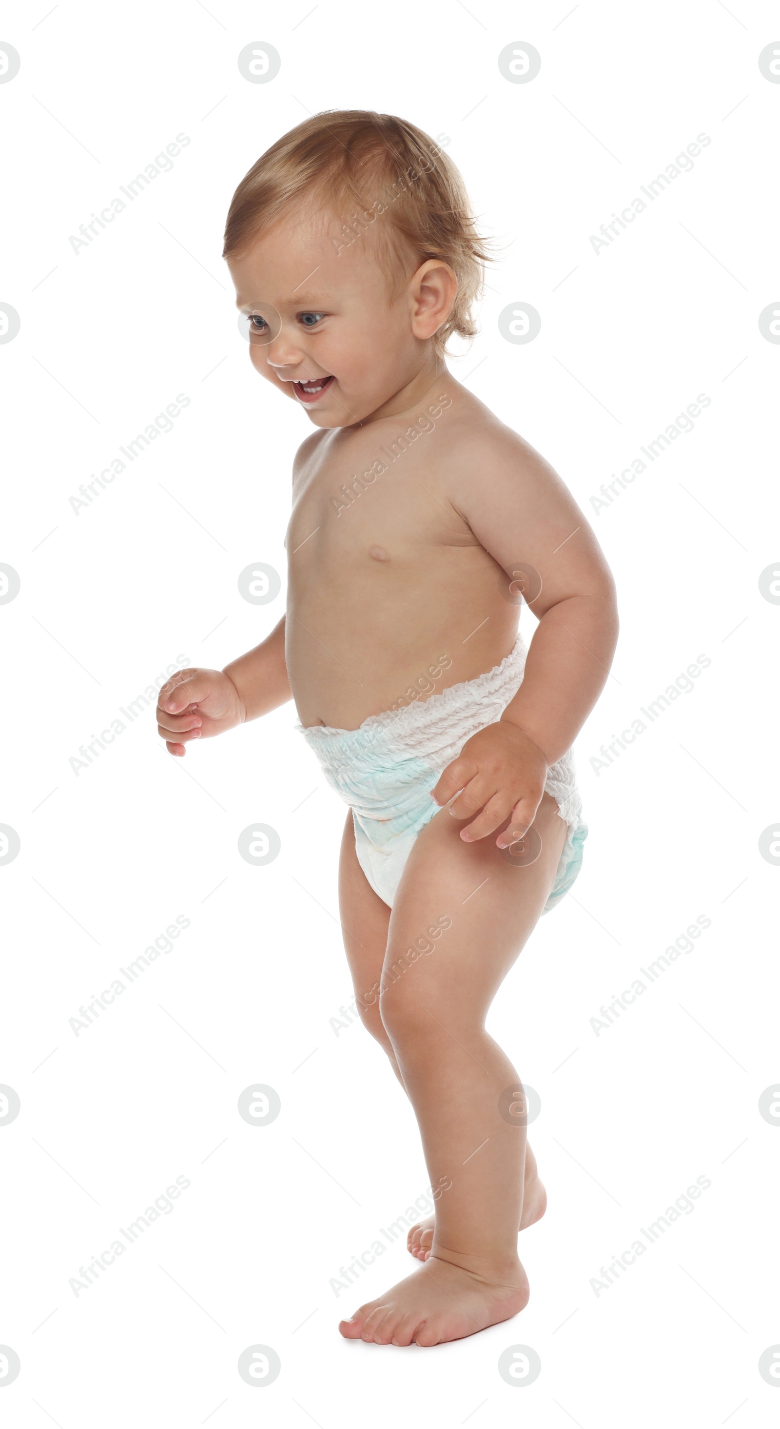 Photo of Cute baby in diaper learning to walk on white background