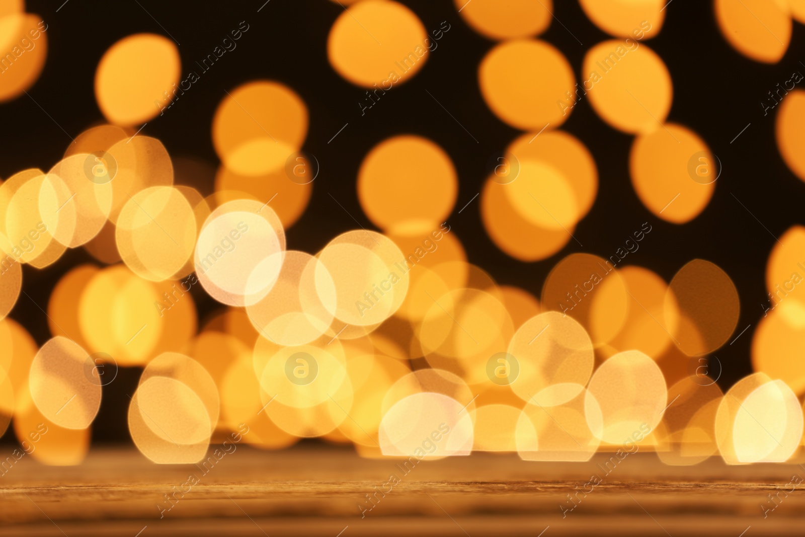 Photo of Empty table against golden bokeh background. Mockup for design