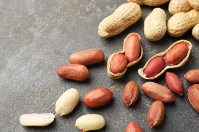 Photo of Fresh peanuts on grey table. Healthy snack