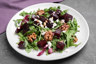 Delicious beet salad served on grey table, closeup