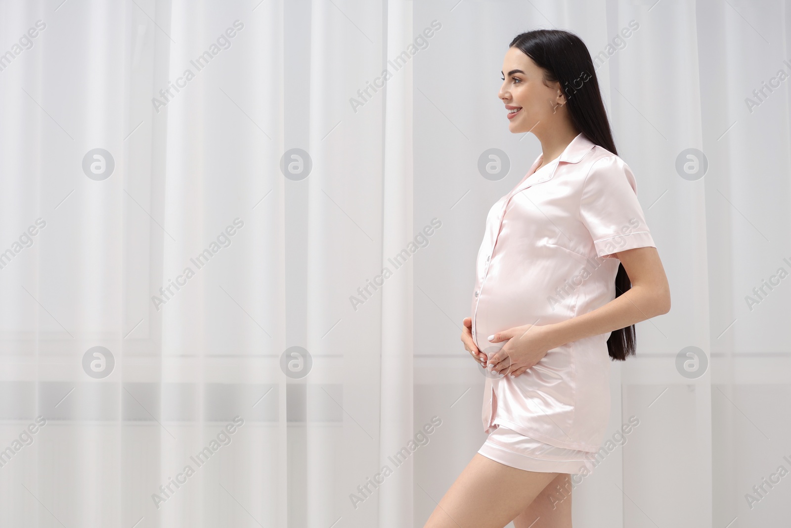 Photo of Happy pregnant woman indoors, space for text