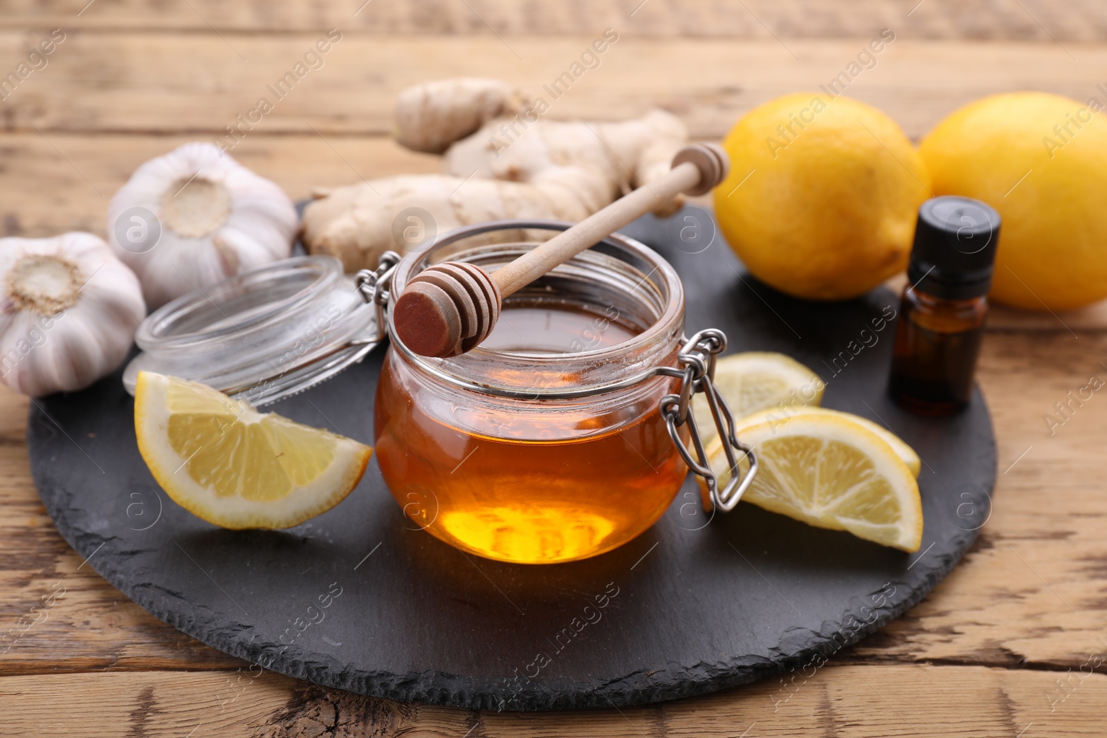 Photo of Cold remedies and syrup on wooden table, closeup. Cough treatment