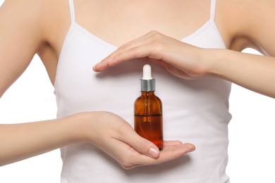 Photo of Young woman with bottle of essential oil on white background, closeup
