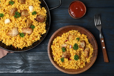 Photo of Flat lay composition with rice pilaf and meat on wooden background