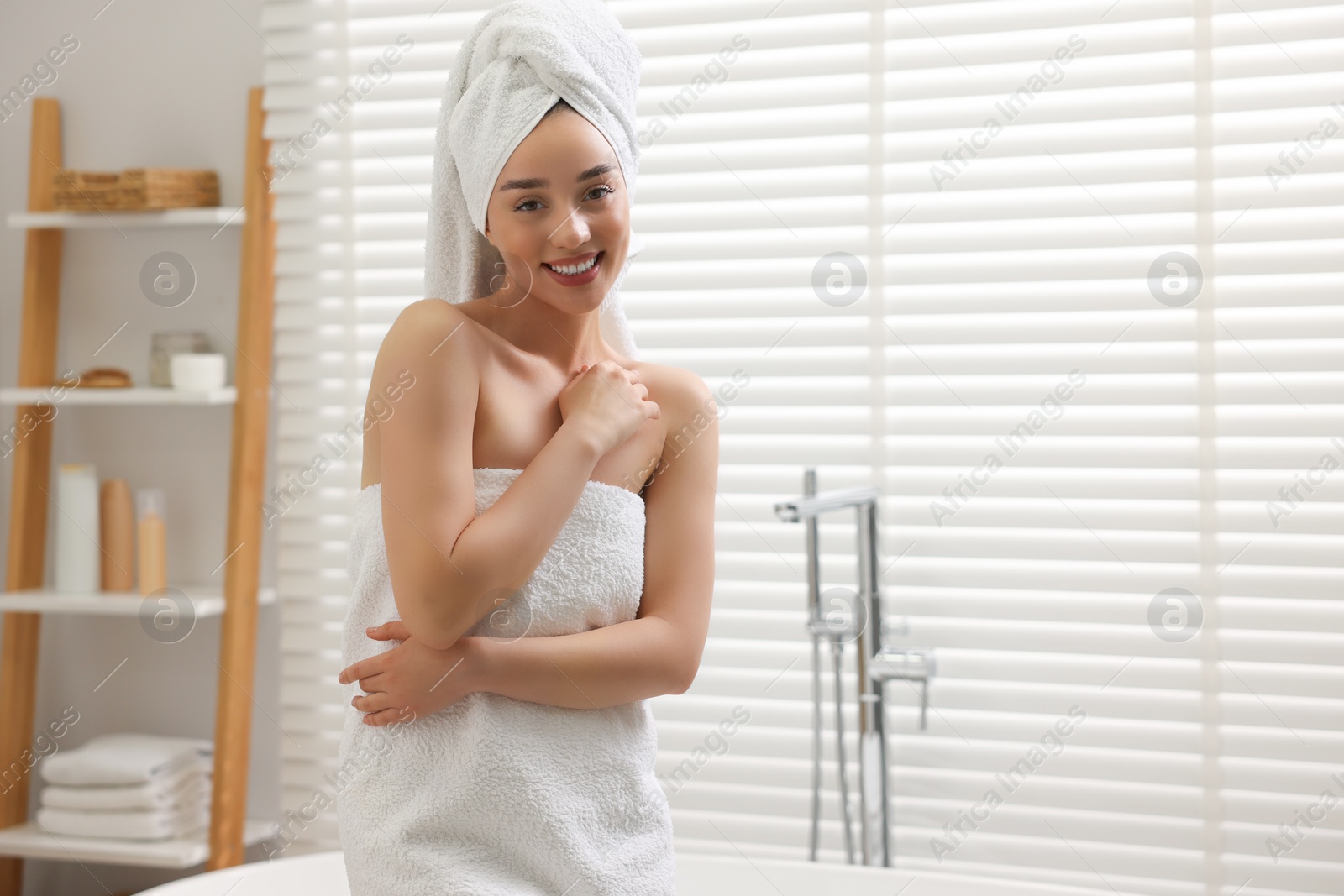 Photo of Smiling woman after shower in bathroom. Space for text