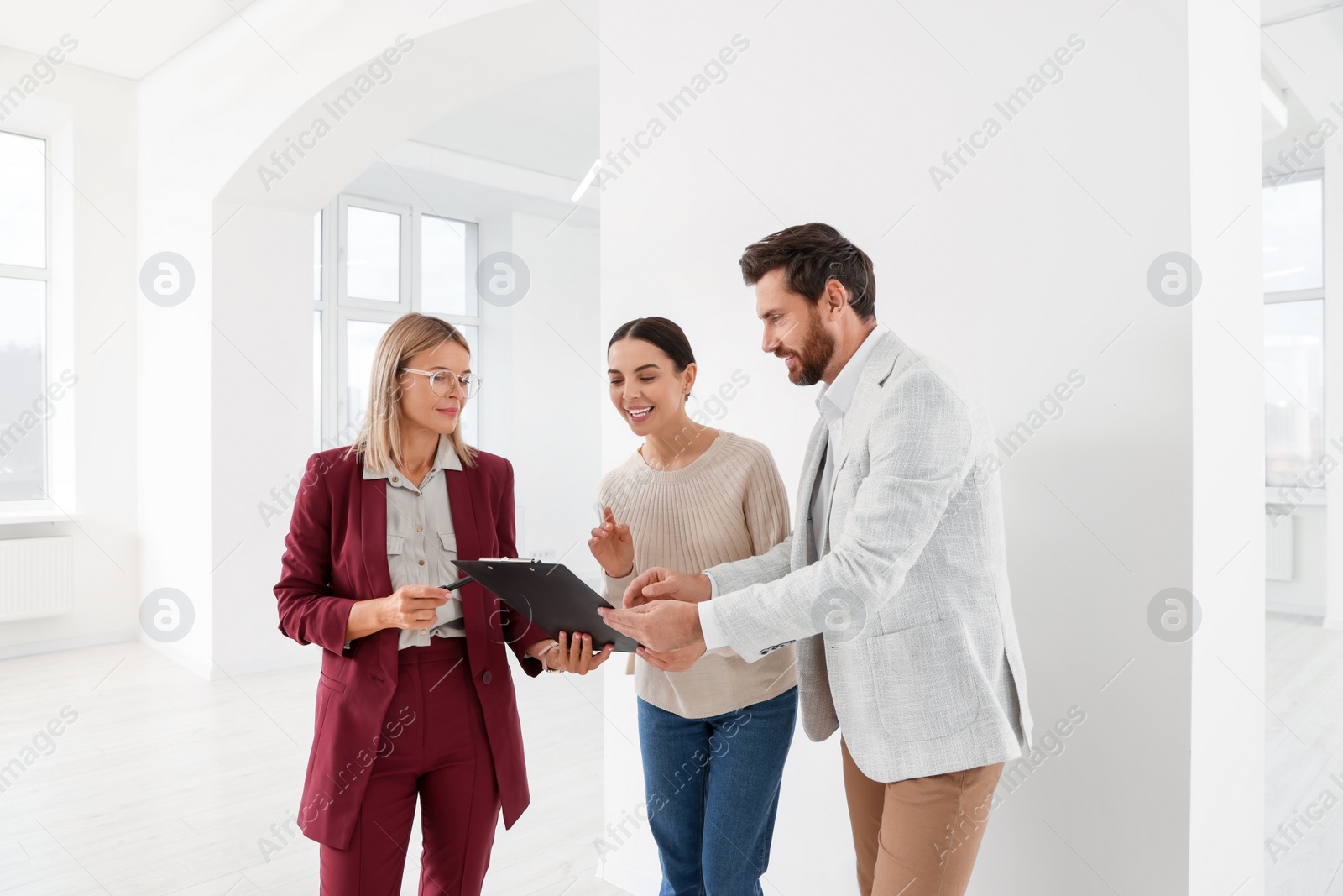 Photo of Real estate agent showing new apartment to couple