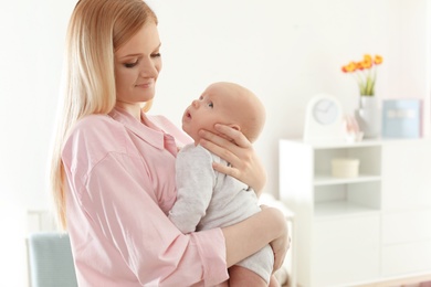 Happy mother and her baby at home