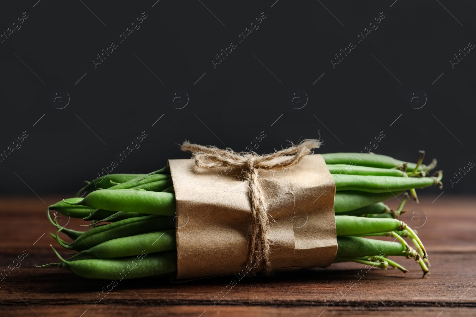 Photo of Fresh green beans on wooden table, closeup