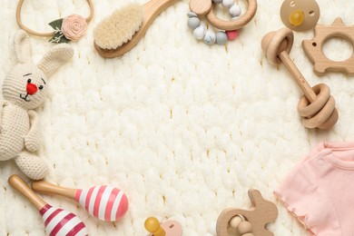 Photo of Frame of different baby stuff on light knitted fabric, flat lay. Space for text