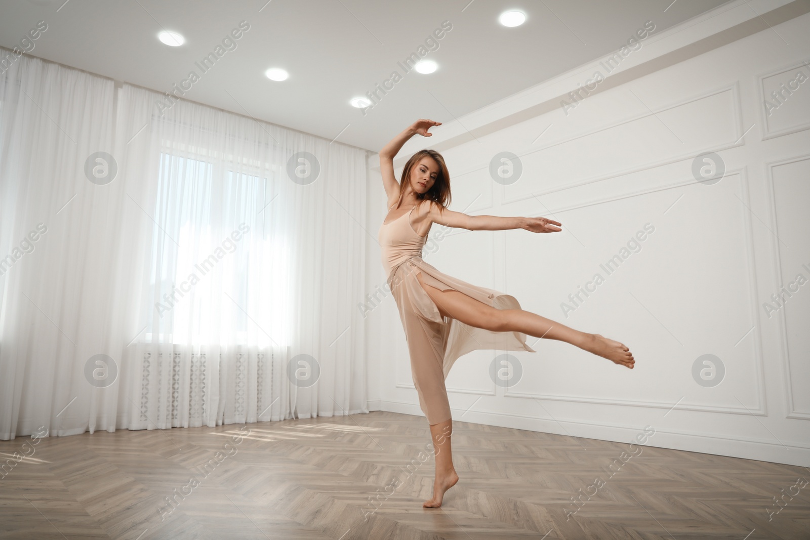 Photo of Beautiful professional dancer practicing moves in studio