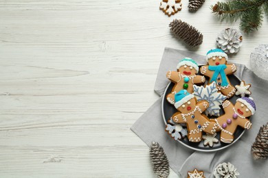 Photo of Delicious Christmas cookies, pine cones and fir branches on white wooden table, flat lay. Space for text