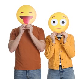 People covering faces with emoticons on white background