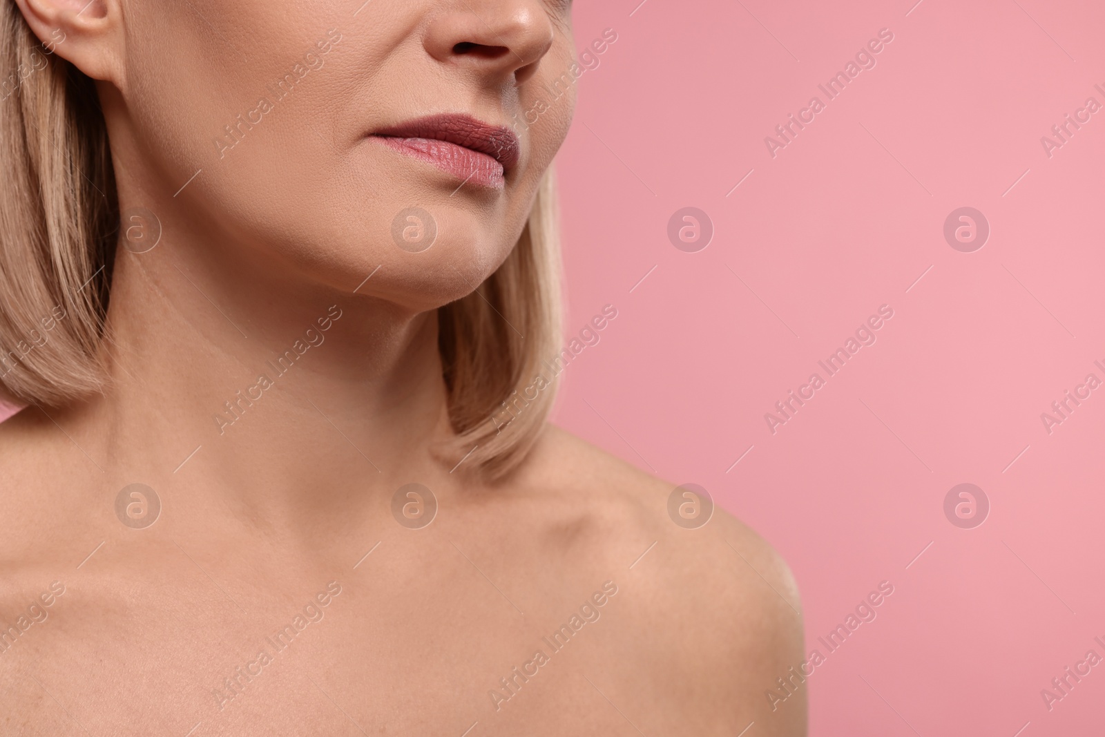 Photo of Woman with healthy skin on pink background, closeup. Space for text