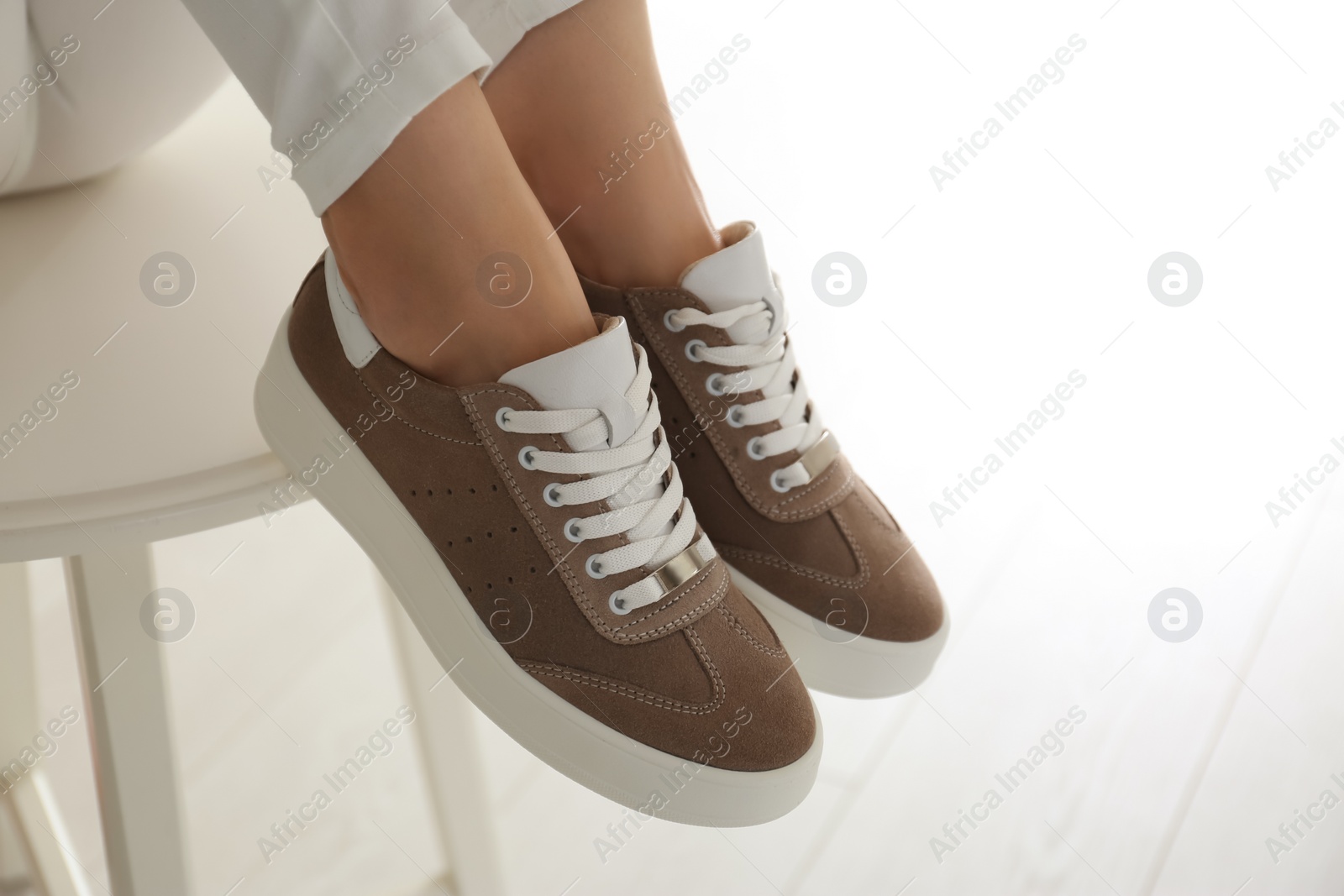 Photo of Woman wearing comfortable stylish shoes indoors, closeup