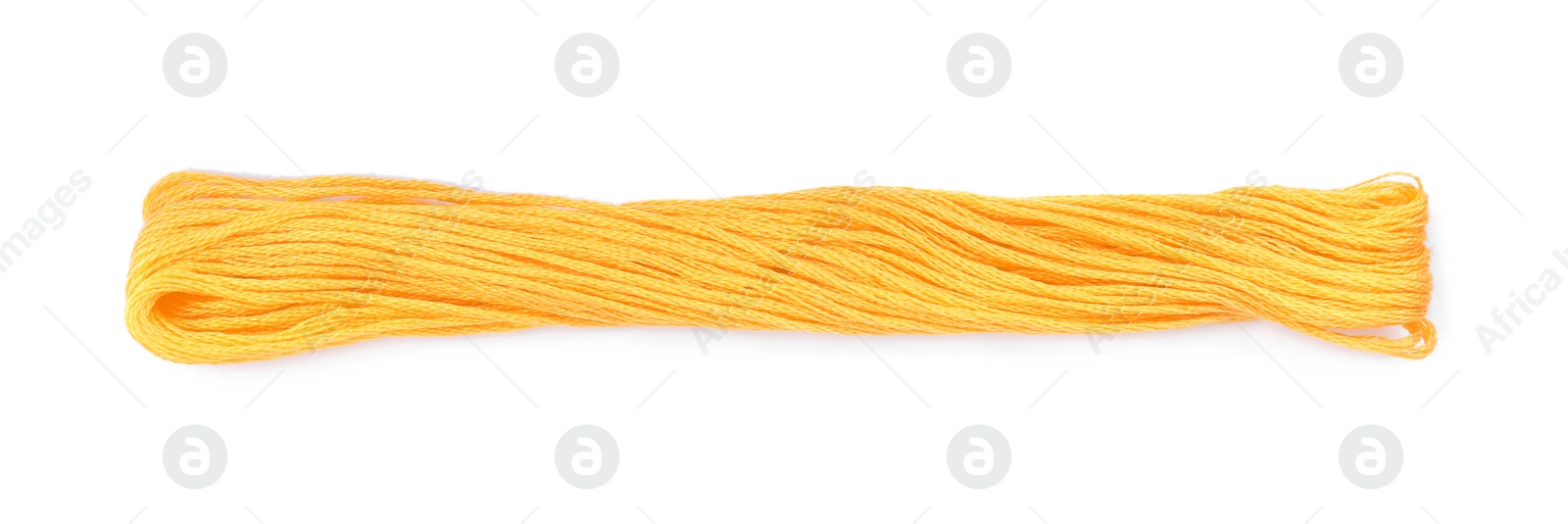 Photo of Bright yellow embroidery thread on white background