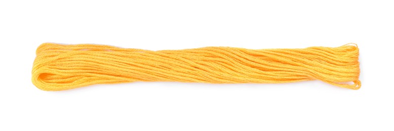 Photo of Bright yellow embroidery thread on white background