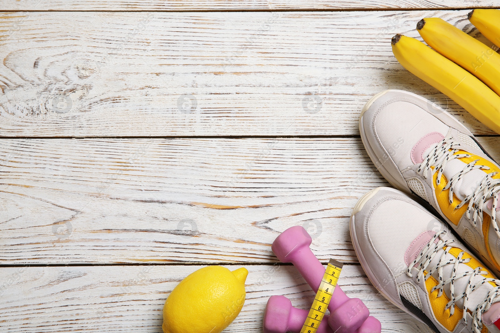 Photo of Flat lay composition with sport items, healthy food and space for text on wooden background. Weight loss concept