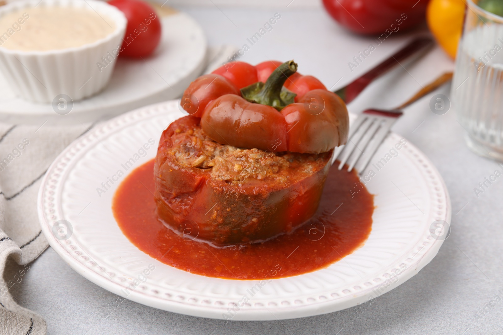 Photo of Delicious stuffed bell pepper served on light table