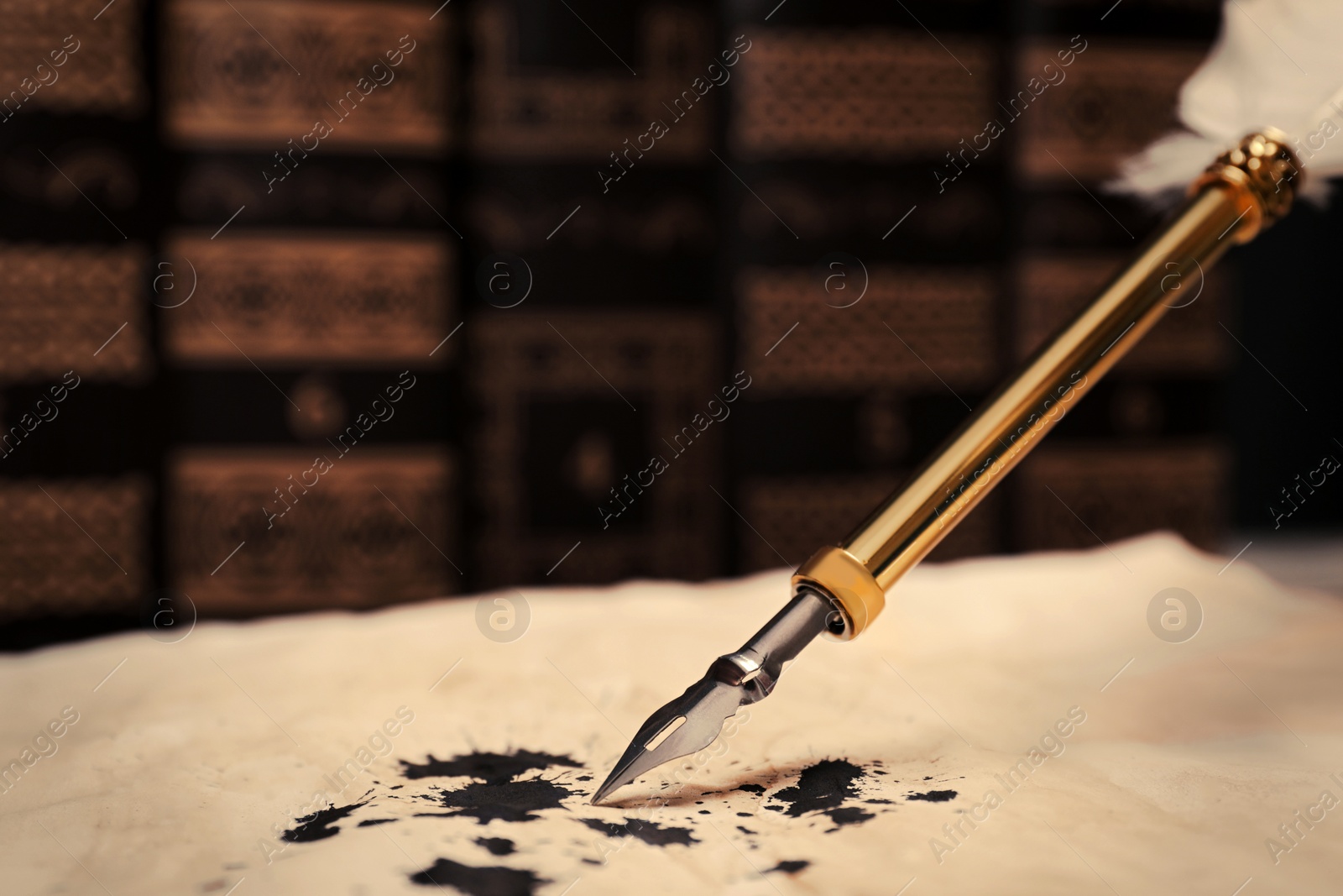 Photo of Feather pen and vintage parchment with ink stains, closeup. Space for text