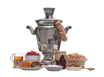 Photo of Traditional Russian samovar and treats on white background