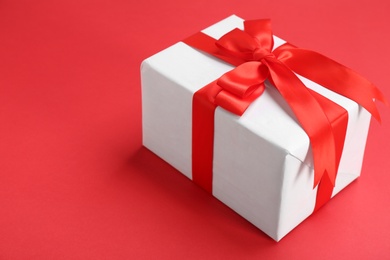 Photo of Beautifully decorated gift box on color background