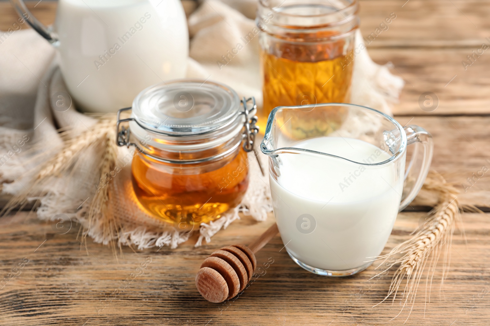 Photo of Beautiful composition with milk and honey on wooden background