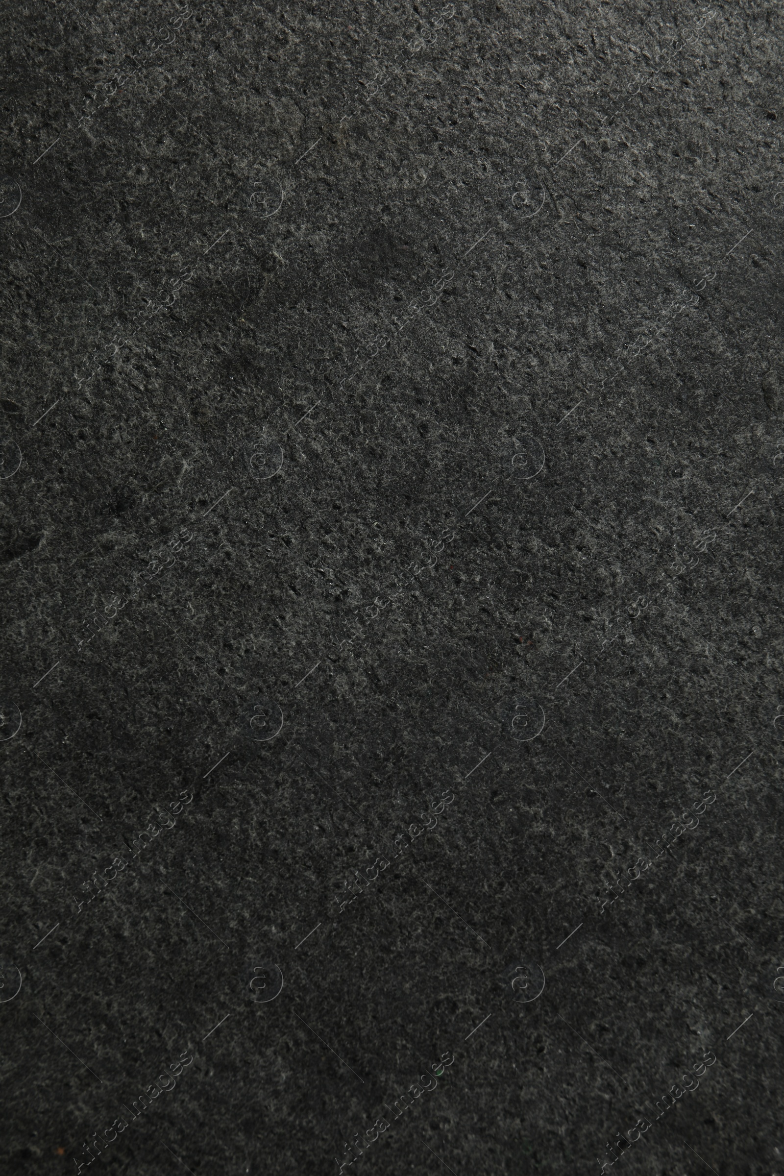 Photo of Texture of dark grey stone surface as background, closeup