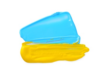 Photo of Light blue and yellow paint samples on white background, top view