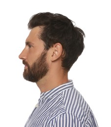 Profile portrait of bearded man on white background